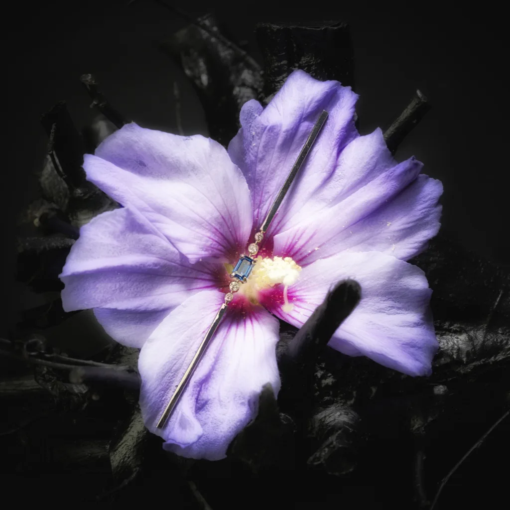 Handmade brooch with sapphire in hibiscus flower.